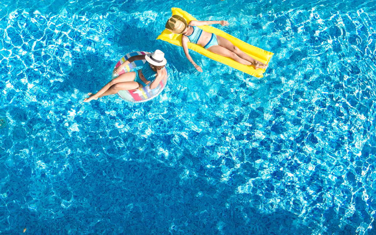 Resident cooling off in the outdoor swimming pool at Evolution at Towne Centre in Laurel, Maryland