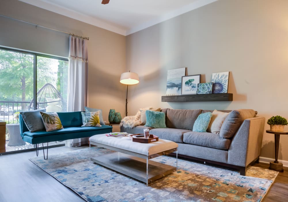 Well-decorated open-concept living space with natural light at Celsius Apartment Homes in Charlotte, North Carolina
