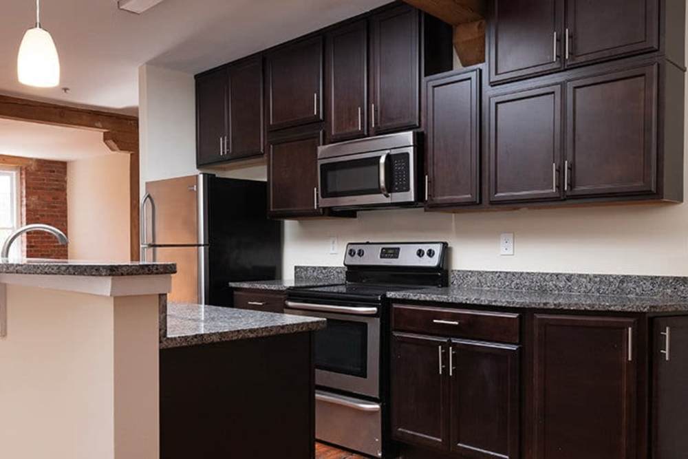 Kitchen with wooden cabinets at High Street Lofts in Petersburg, Virginia