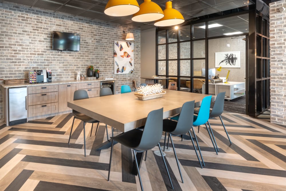 Coffee bar and long table with pendant lighting in the beautiful modern clubhouse at 75 West in Dallas, Texas
