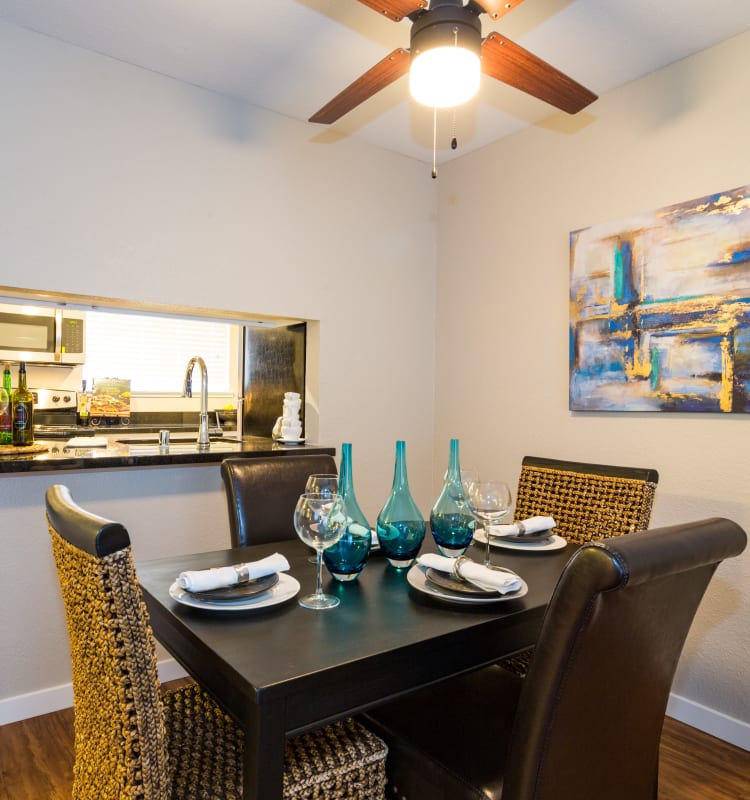 Dining room with a ceiling fan and wood-style flooring in a model home at Haven Martinez in Martinez, California