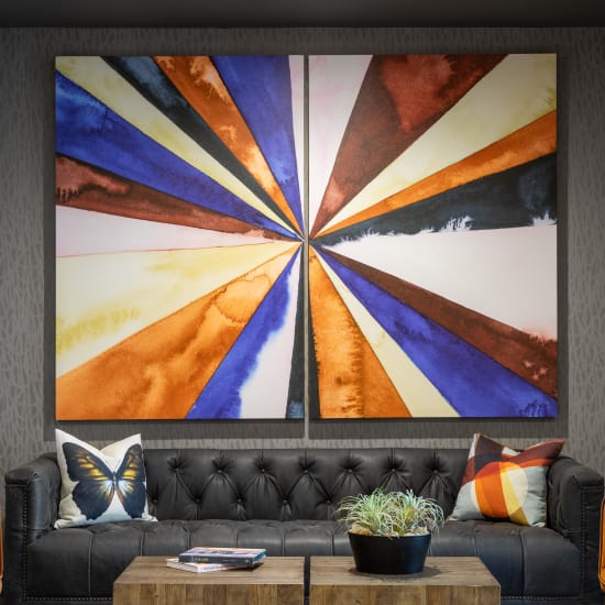 Trendy leather sofa with large artwork on the wall at Bellrock Sawyer Yards in Houston, Texas