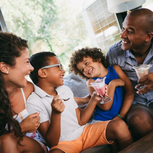 Happy family eating as ice cream near Adobe Flats I in Twentynine Palms, California