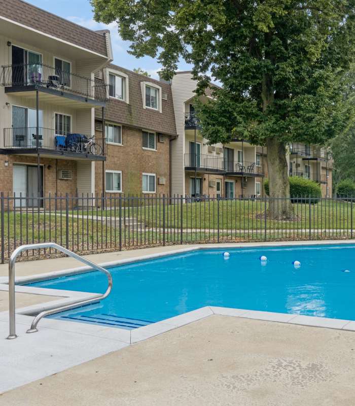 Swimming in pool with lounge chair at Broadway Crossing Apartments in Merrillville, Indiana