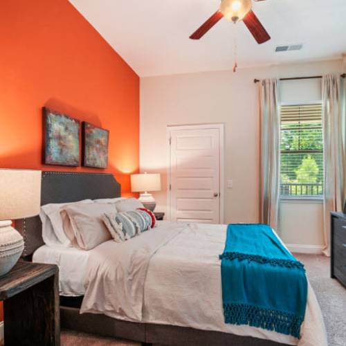 Bedroom with ceiling fan and window at Lodge at Lake Wylie in Lake Wylie, South Carolina