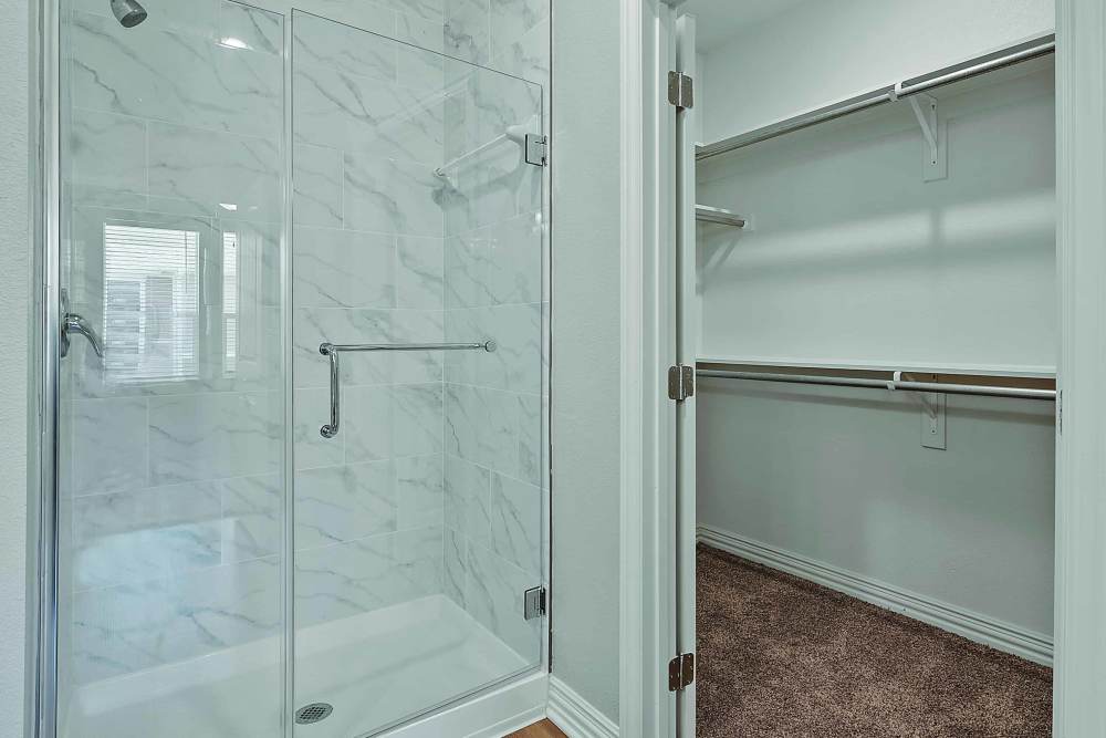 Bathroom with shower area and storage spaces at Stonebridge Apartment Homes in Lufkin,Texas