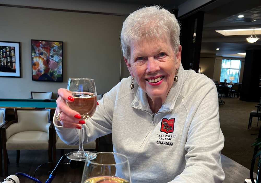 Resident with a glass of wine at Merrill Gardens at Tacoma in Tacoma, Washington