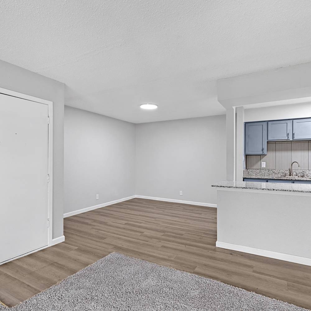 Model apartment with wood-style flooring at La Nueva Casa Grande in Brownsville, Texas