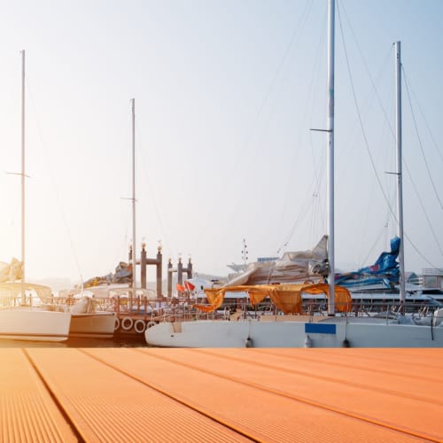 Afternoon view of boats in slips from the dock at the marina at Portside Ventura Harbor in Ventura, California