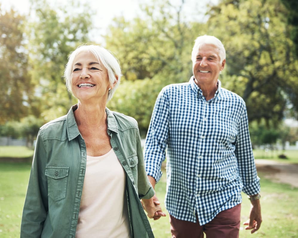 Senior couple walking outside near Brown Deer Place in Coralville, Iowa.