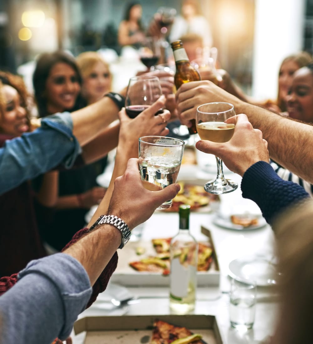 Group of resident friends out for a meal at their favorite restaurant and raising a toast to the good life at Sofi Warner Center in Woodland Hills, California