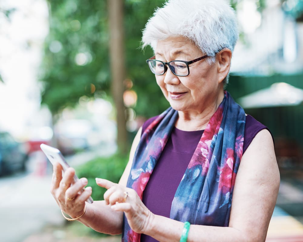Resident using her phone near WellQuest of Menifee Lakes in Menifee, California