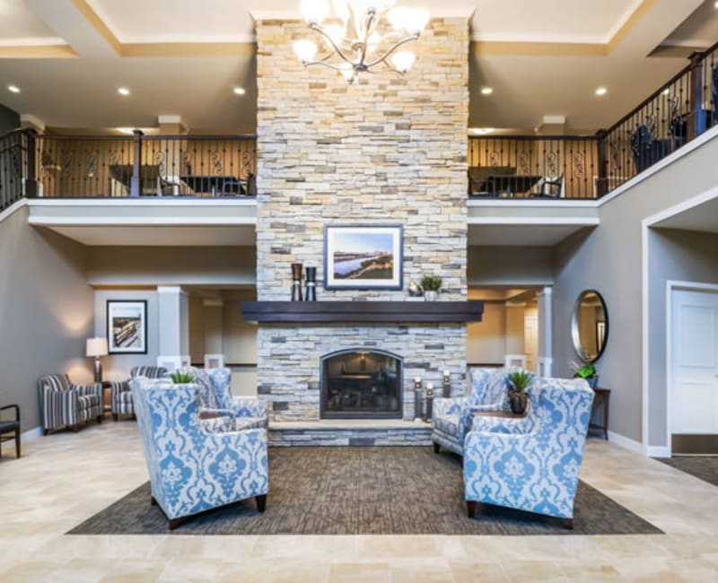 Modern reception area with cozy furniture next to a fireplace at The Sanctuary at West St. Paul in West St. Paul, Minnesota