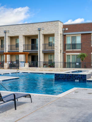 Exterior of apartments and pool at The Gates at Meadow Place in Willow Park, Texas