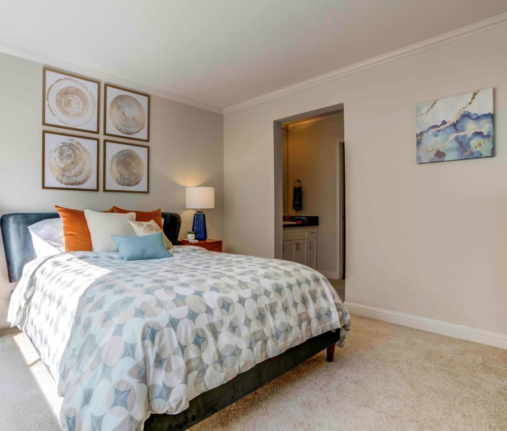 Well-decorated master bedroom with plush carpeting and mirrored closet doors in a model home at Sofi Redwood Park in Redwood City, California