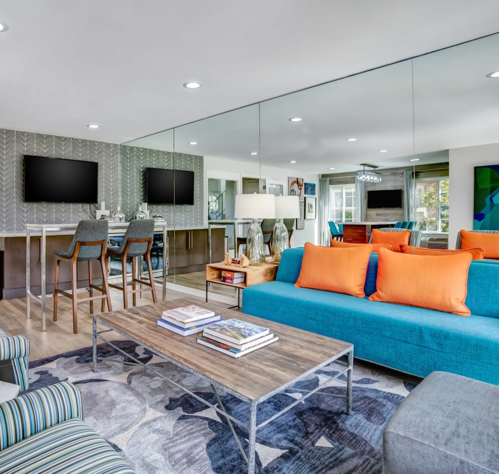 Modern decor and a large flatscreen TV in the resident clubhouse at Sofi at Los Gatos Creek in San Jose, California
