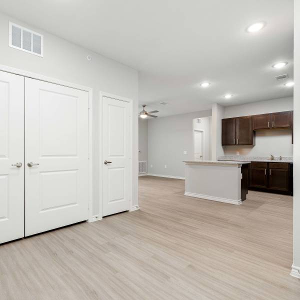 Open layout with wood-style flooring at Redwood in San Marcos, Texas
