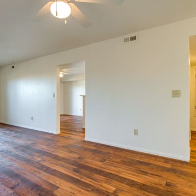 Well-lit living room with wood flooring in a home at Del Mar I in Oceanside, California