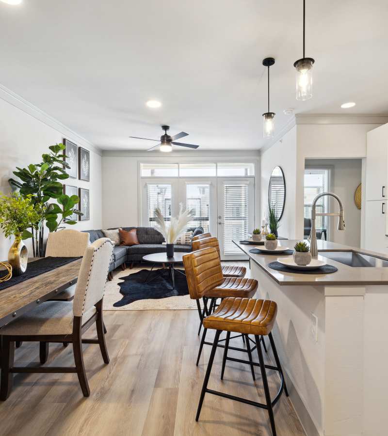 Wooden dining table with beige chairs at Dakota at Deer Park in Deer Park, Texas