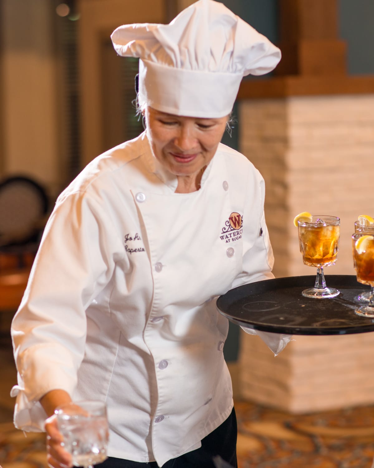 A waiter serving drinks at Watercrest at Kingwood in Kingwood, Texas