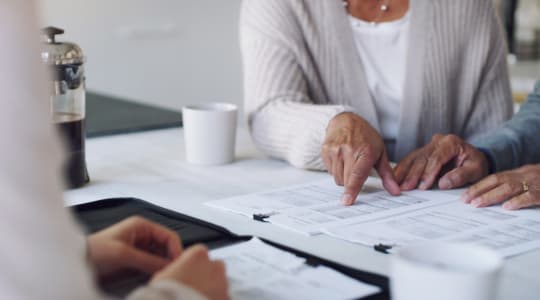 Assisted living resident discussing care options with family members and a caregiver at 6th Ave Senior Living in Tacoma, Washington