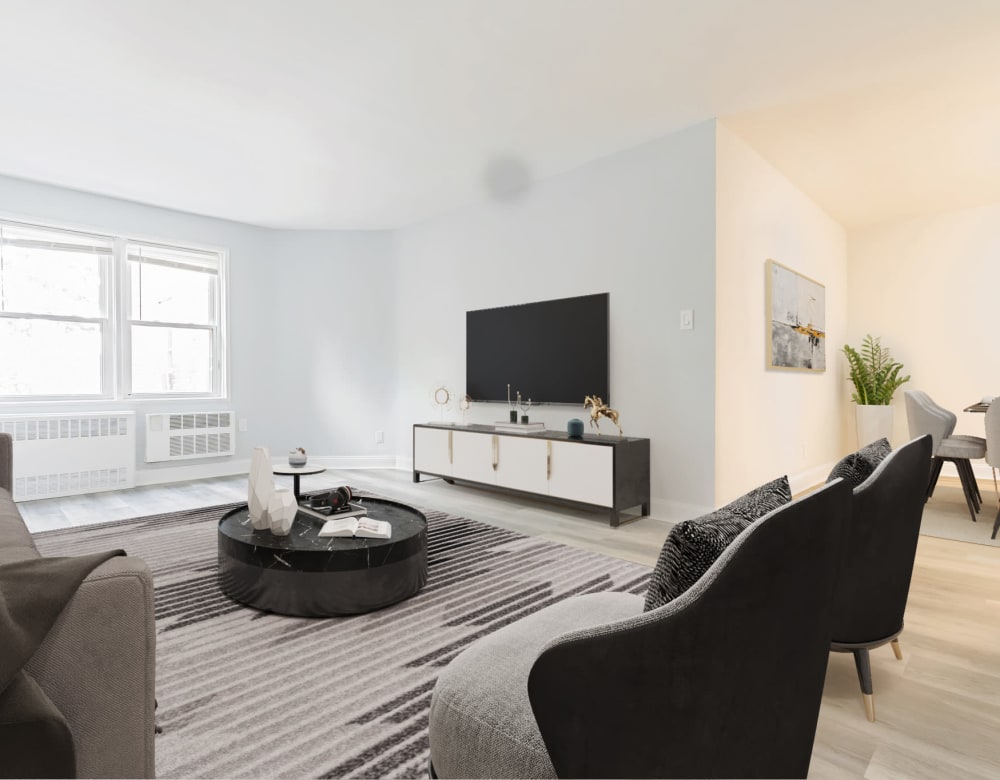 Wide living room with hardwood floors at Bergen Apartments in Freeport, New York