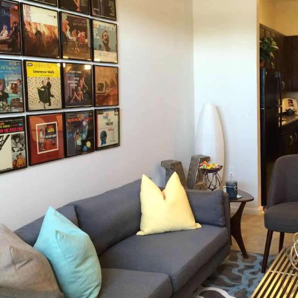 Cool album art behind the cozy couch in the living room at The Morgan in Chesapeake, Virginia