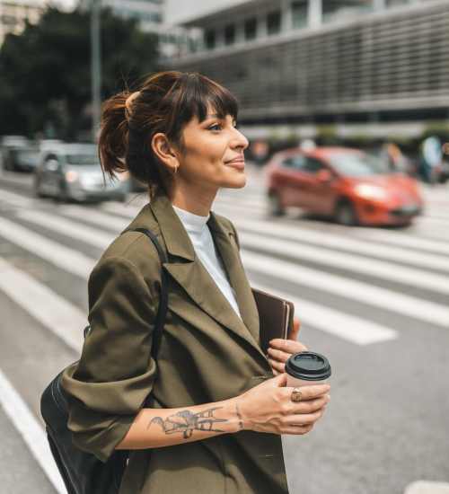 Woman with coffee walking downtown near Anchor Apartments in Freeport, Florida