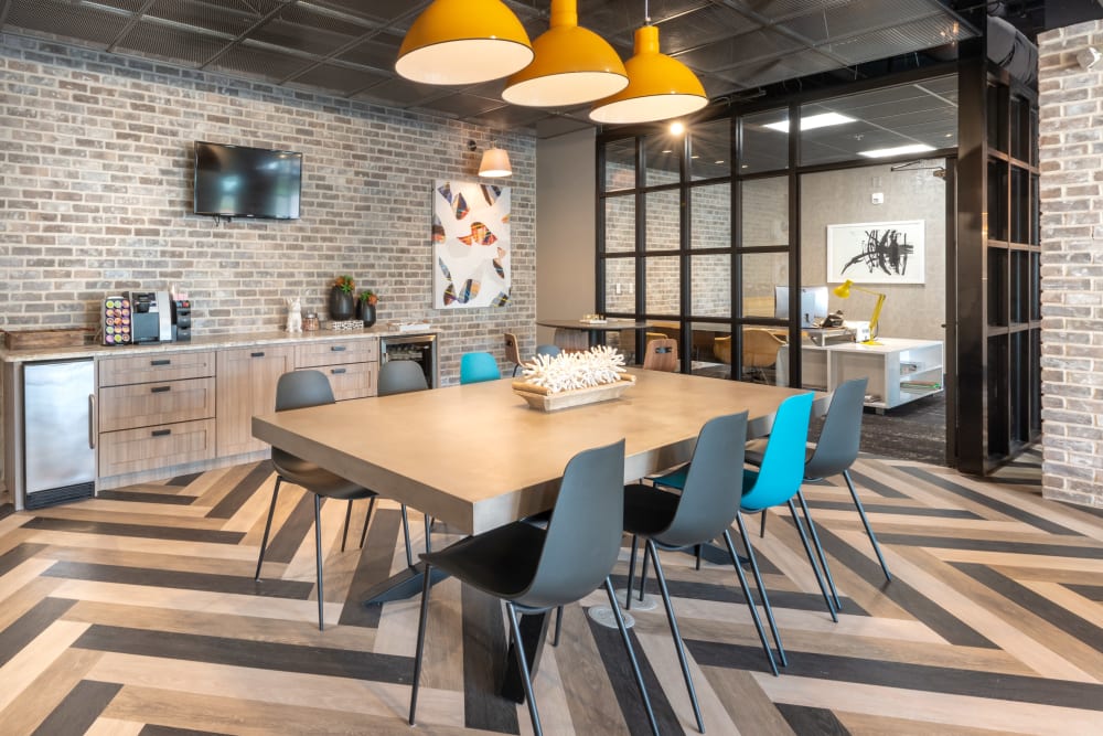 Coffee bar and long table in the beautiful modern clubhouse at 75 West in Dallas, Texas
