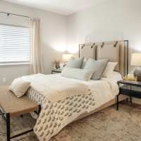 Modern furnishings in a model apartment's primary bedroom at InterUrban 2.0 in Billings, Montana