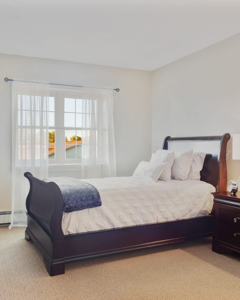 Bed in a 1 bedroom senior apartment at The Hearth at Greenpoint in Liverpool, New York