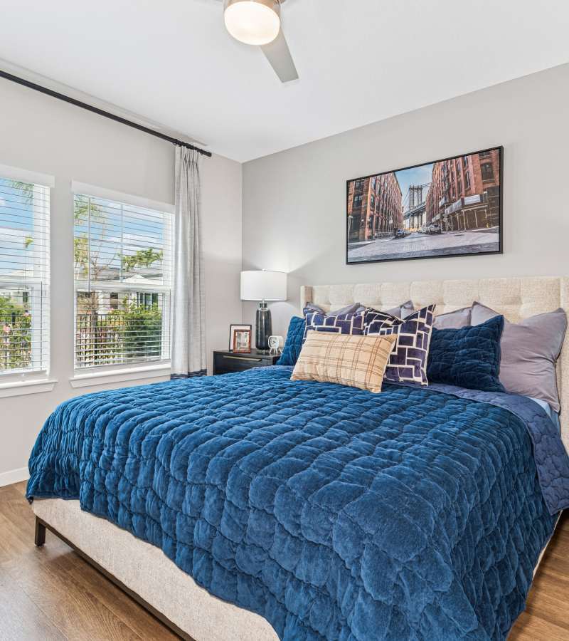 Cozy bedroom with bright windows at Savelle Nona West in Orlando, Florida