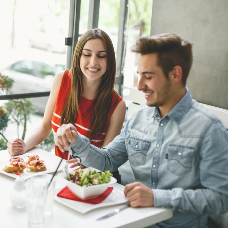 A couple having a lunch at a restaurant near Village Green of Bear Creek in Euless, Texas