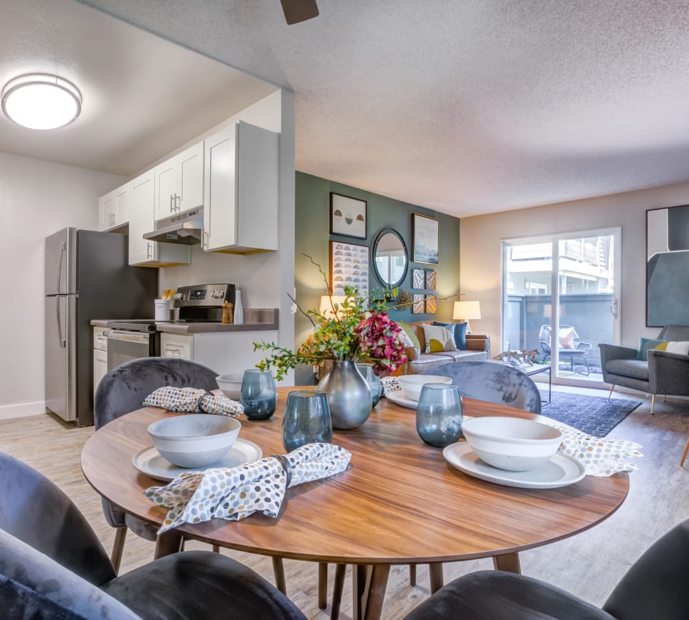 Open-concept floor plan with a view of the kitchen and living area from the dining nook of a model home at Sofi Union City in Union City, California