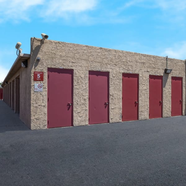 Outdoor storage unit with a red door at StorQuest Self Storage in Phoenix, Arizona