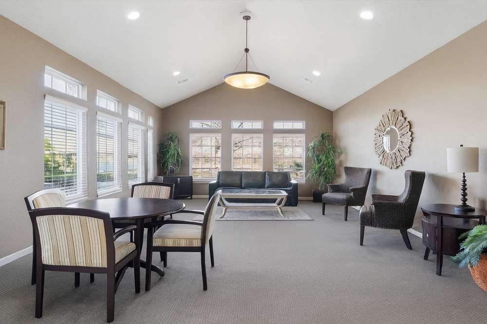 Bright and inviting living space with large windows and modern decor at Covington Woods Apartments in Lansing, Kansas.