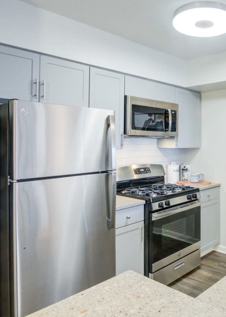 Modern kitchen with granite countertops in a model home at Sofi at 50 Forest in Stamford, Connecticut