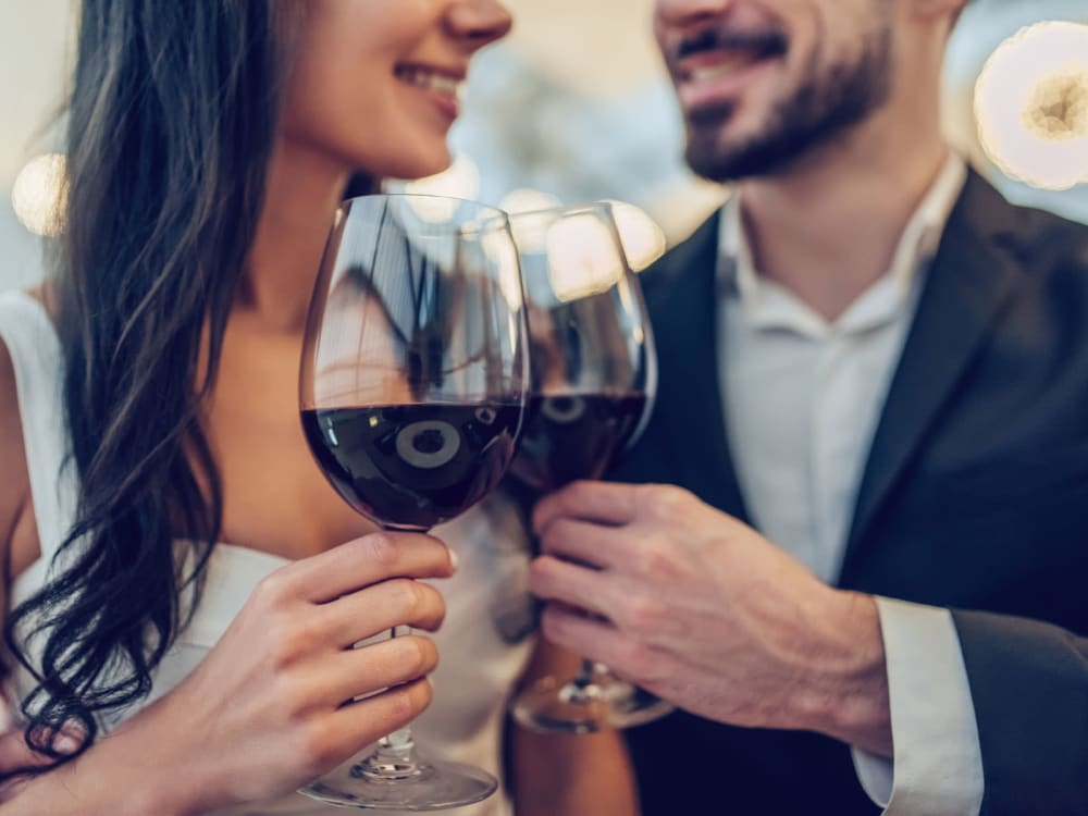 Resident couple enjoying glasses of red wine near Aviva Goodyear in Goodyear, Arizona