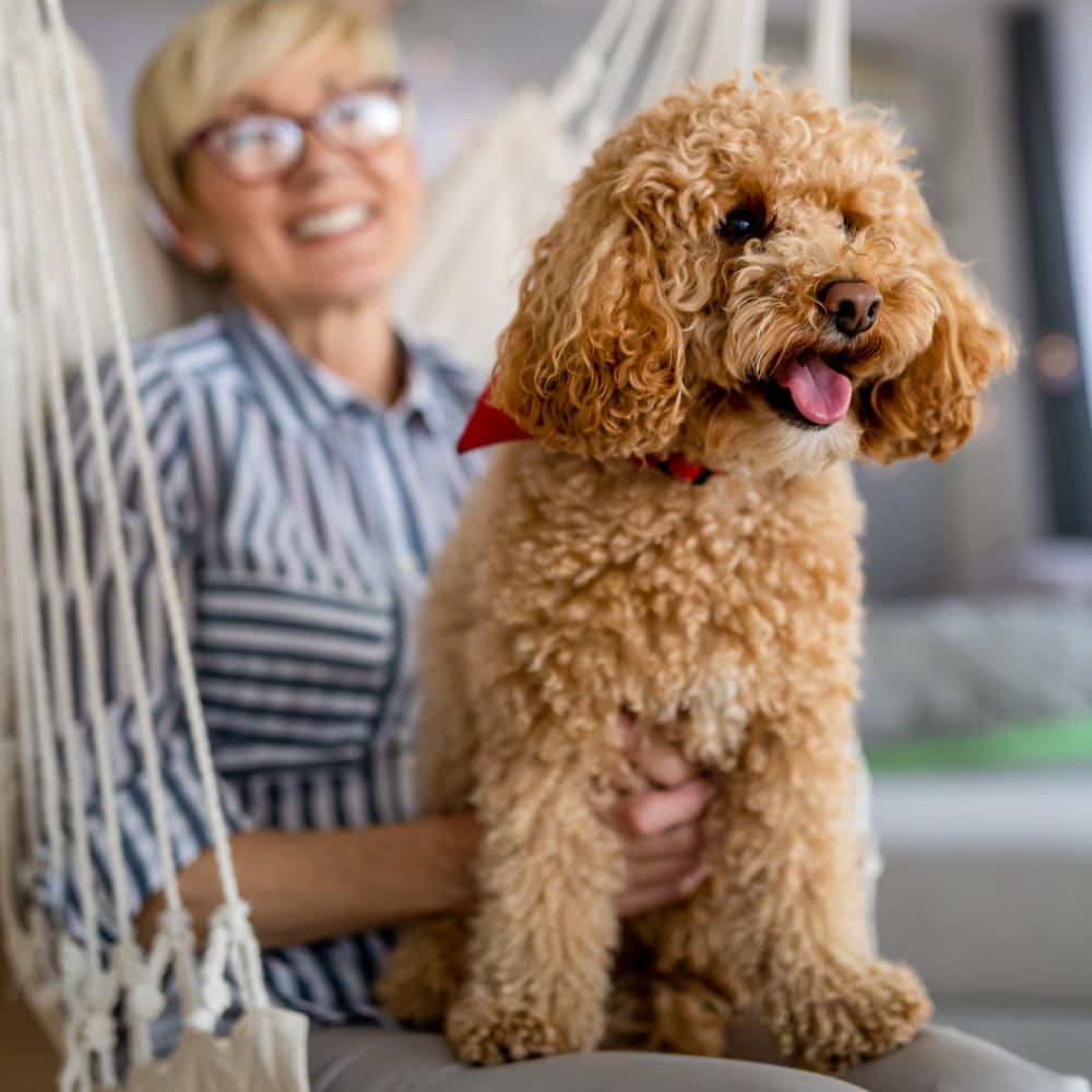 A resident and her dog at a Ridgeline Management Company senior living property