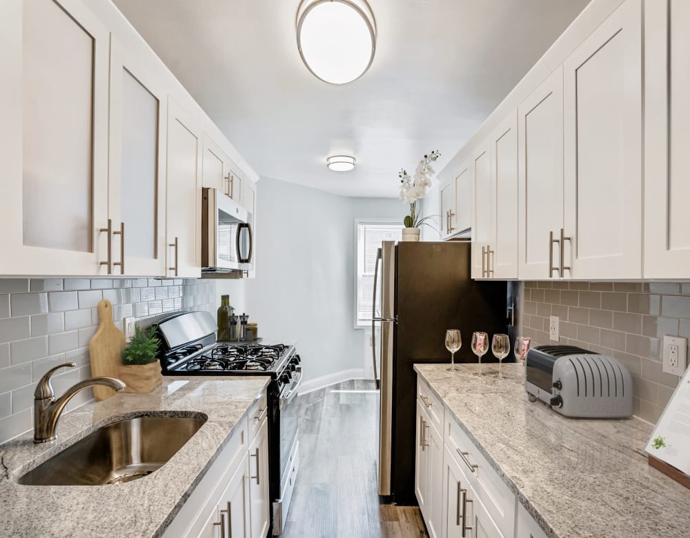 Galley style kitchen at Bergen Apartments in Freeport, New York