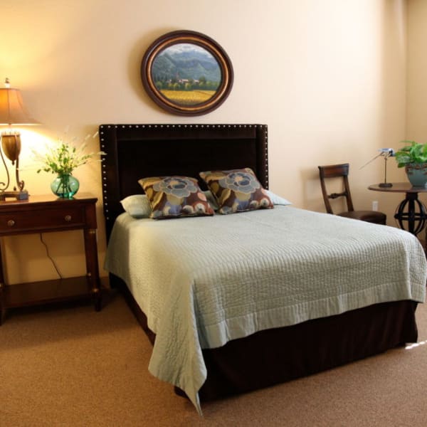 Bedroom in an apartment at Quail Park Memory Care Residences of Visalia in Visalia, California