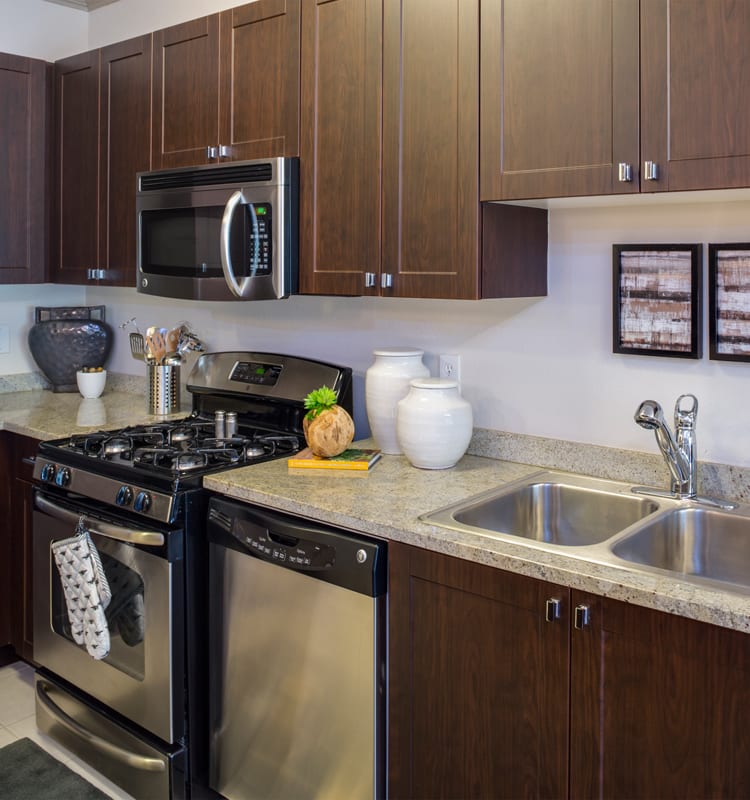 Kitchen with granite countertops and updated appliances at 17 Barkley in Gaithersburg, Maryland