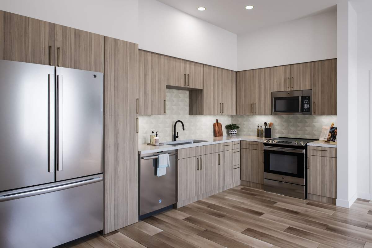 Modern kitchen with living room and natural light at Colony Parc in Ventura, California 