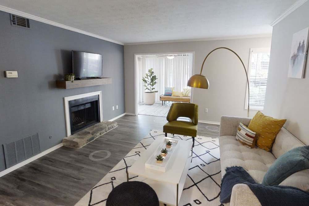 Modern living room with large coush, chairs. coffee table and fireplace at Preserve at Dunwoody in Dunwoody, Georgia