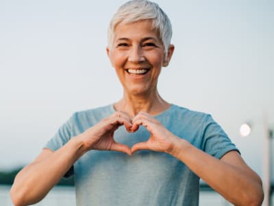 Senior woman making heart with hands