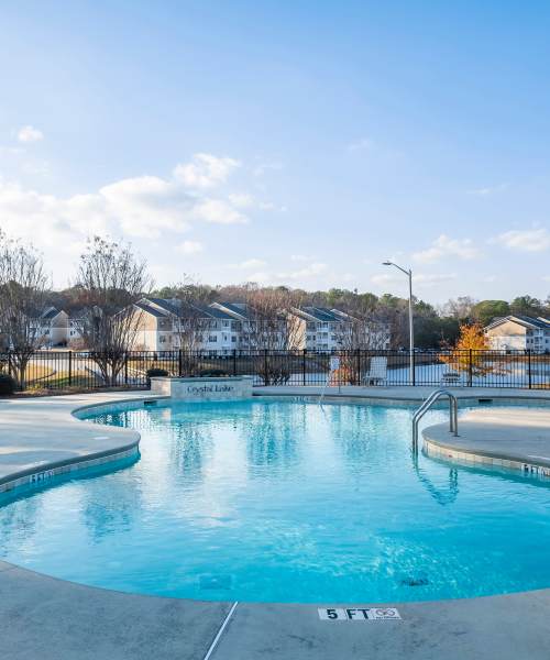 Community swimming pool at Crystal Lake & Kingsley Apartments and Townhomes in Fayetteville, North Carolina