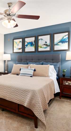Bedroom with butterfly pillow in bed at The Abbey At Enclave in Houston, Texas