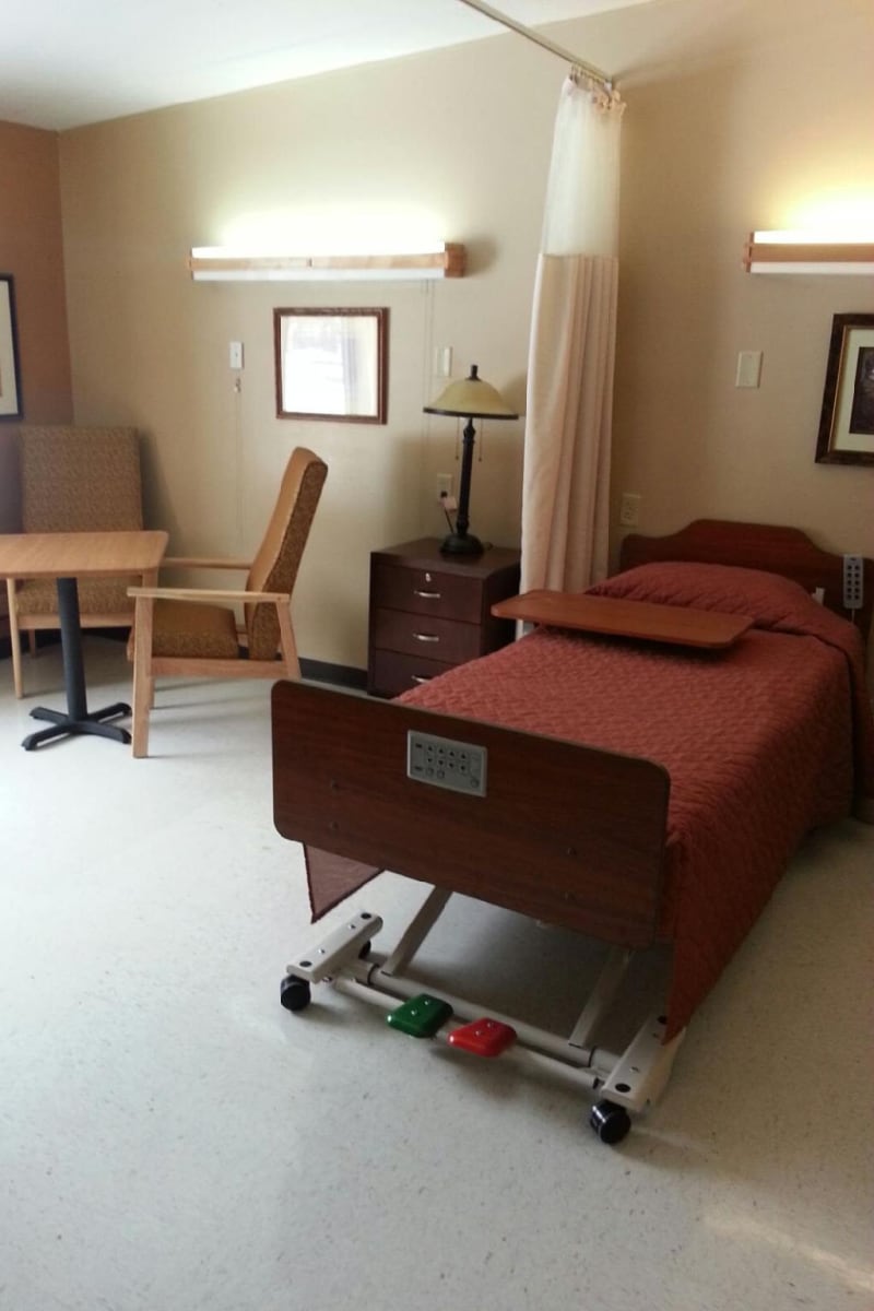 Single-resident room with a wheel-bed and tv at Montello Care Center in Montello, Wisconsin