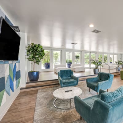 Spacious community room with a wall full of windows letting in natural light at The Villas at Woodland Hills in Woodland Hills, California