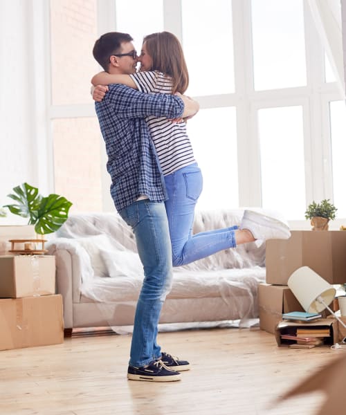 A happy couple moving boxes from A+ Self Storage into their new home in Woodburn, Oregon
